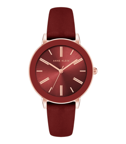 A red watch with a rose gold face and a burgundy strap.