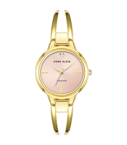 A gold watch with pink face and gold band.