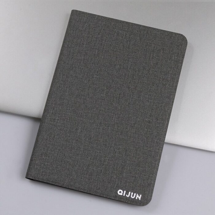 A notebook with a cover on top of it.