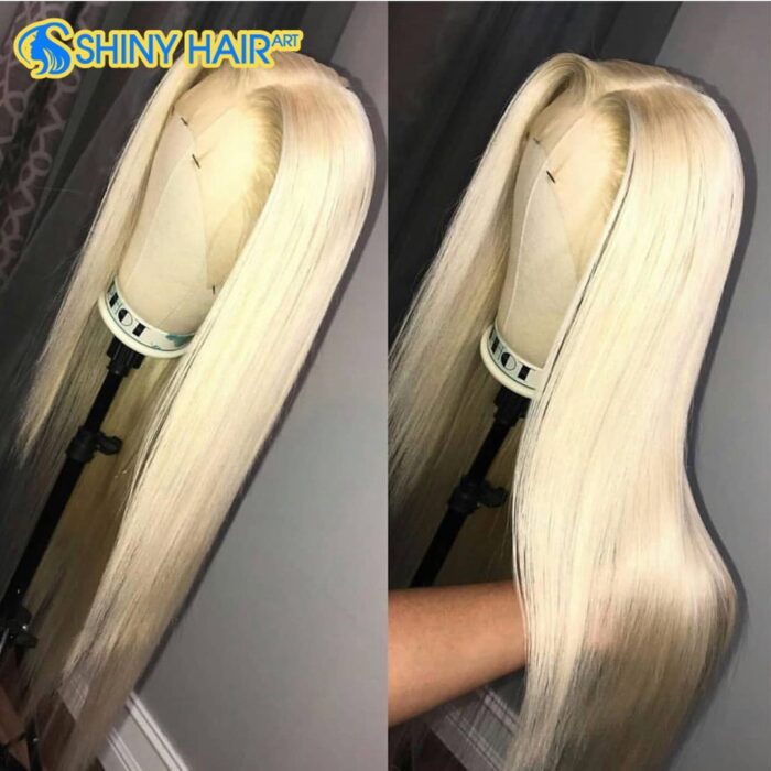 A woman is holding her long blonde hair.