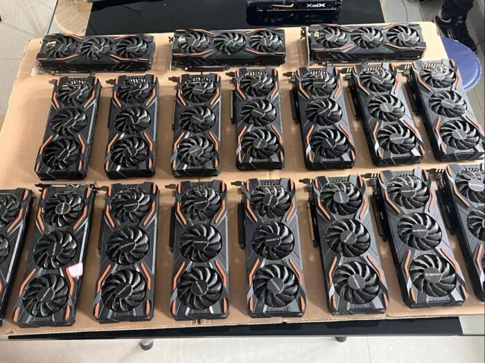 A large group of computer fans sitting on top of cardboard.