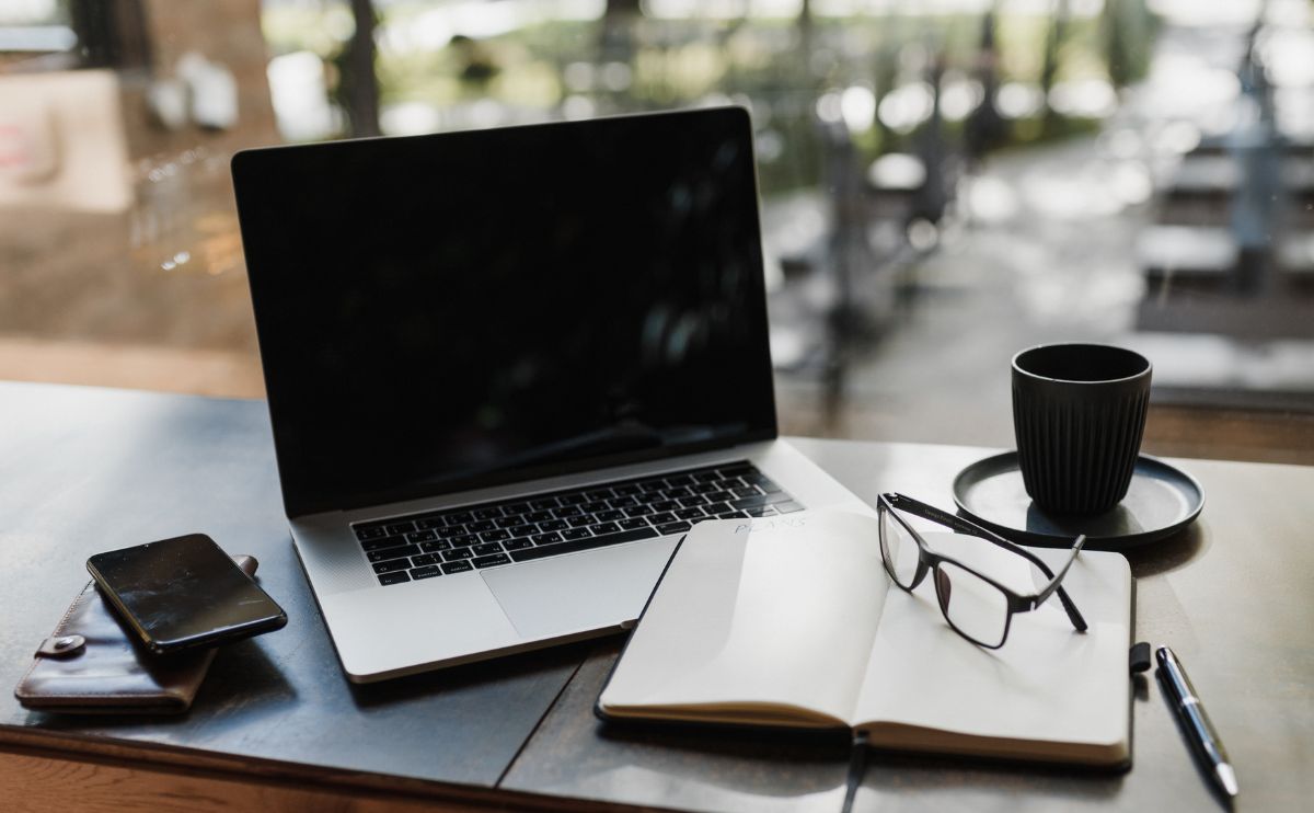 A laptop and glasses on the table