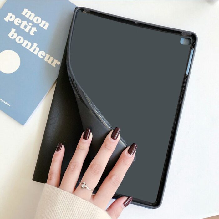 A person holding an ipad with a black case